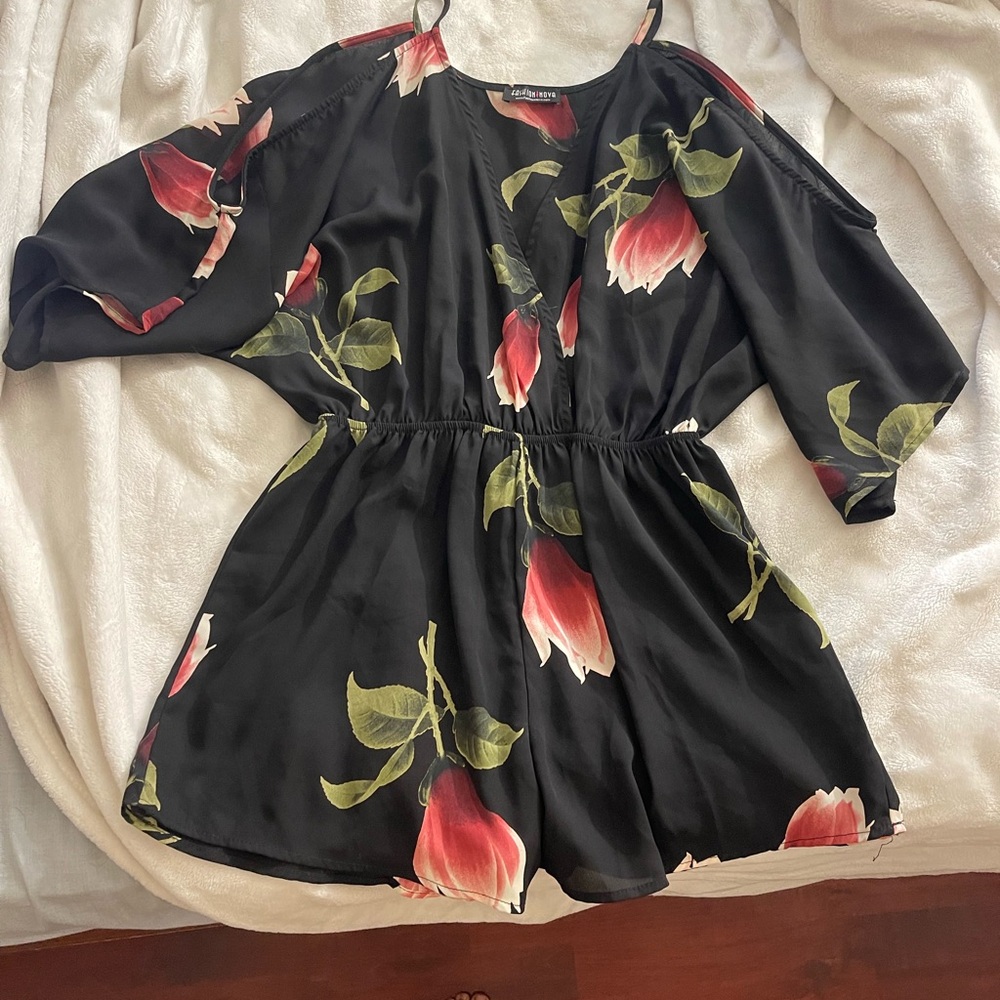Black and pink romper with a floral design from Fashion Nova